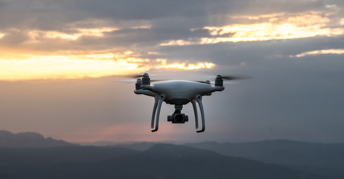 DJI Phantom 4 in sky with Mountains in background 1200x625